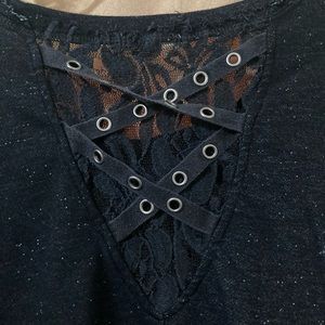 Distressed black long sleeved top with lace on back.